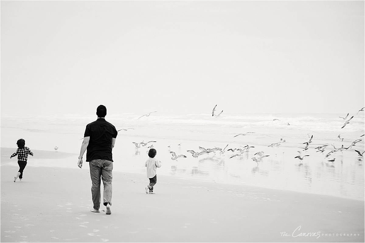 father and sons on beach